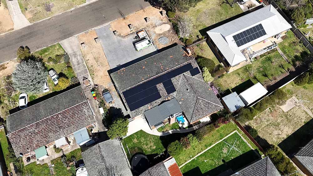 Top Aerial View Of A Community House With Solar Panels On The Roof — Goulburn Solar In Narooma, NSW
