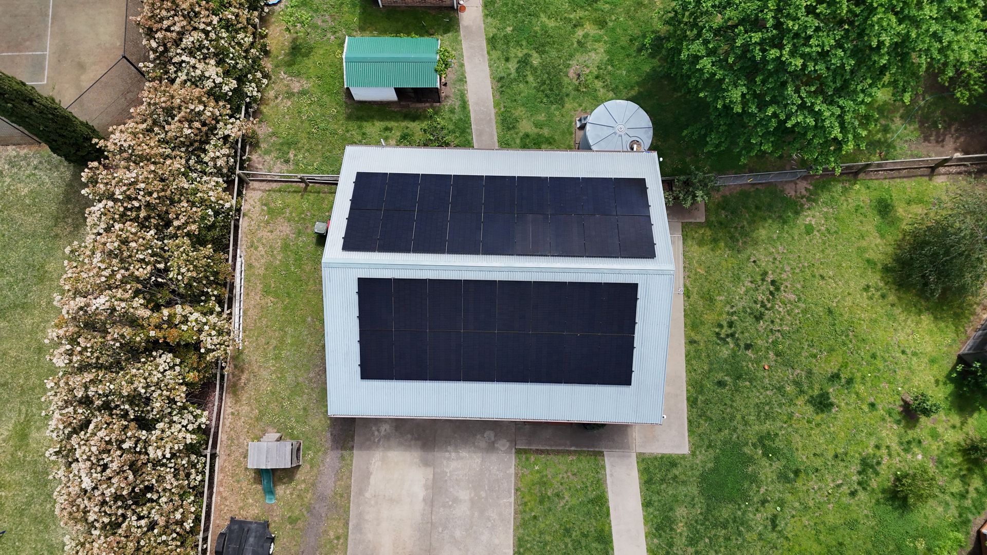 Aerial View of A House with A Large Black Solar Panel Roof — Goulburn Solar In Goulburn, NSW
