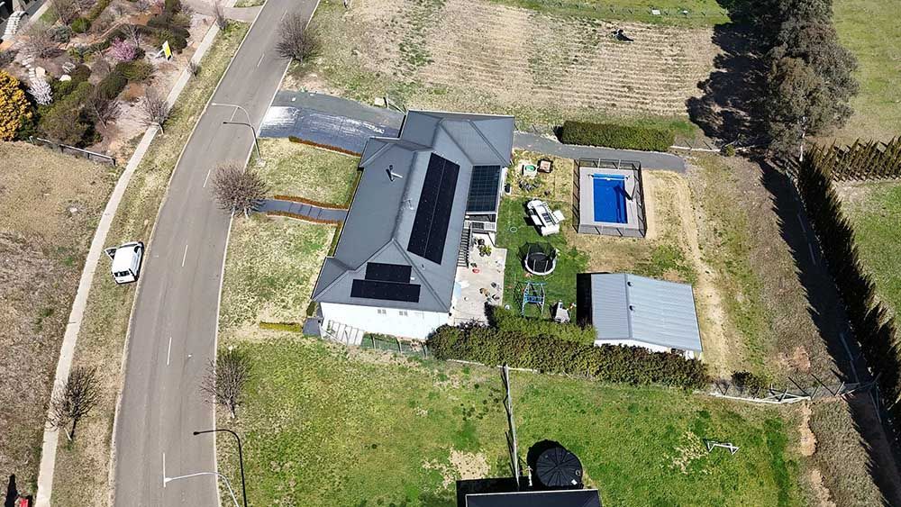 Aerial View Of A Residential House With Solar Panels On The Roof — Goulburn Solar In Goulburn, NSW