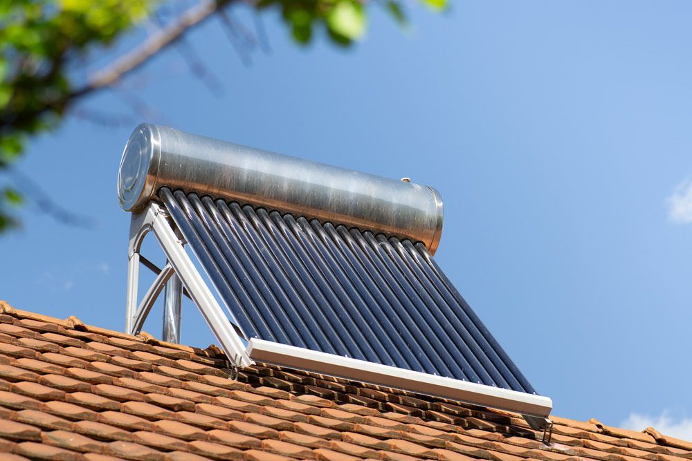 A Solar Water Heater is Sitting on Top of a Tiled Roof — Goulburn Solar In Picton, NSW