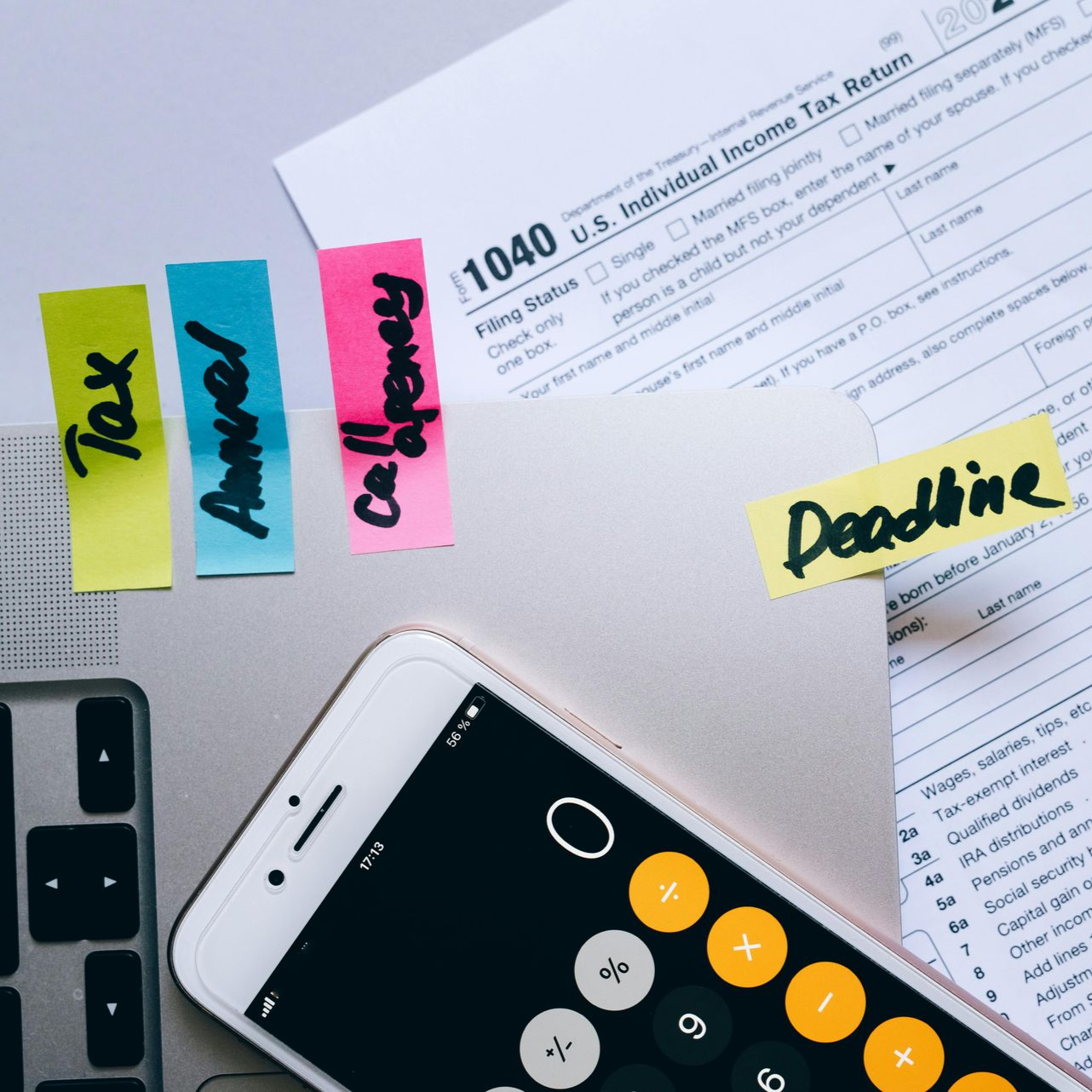Tax forms with sticky notes reading 