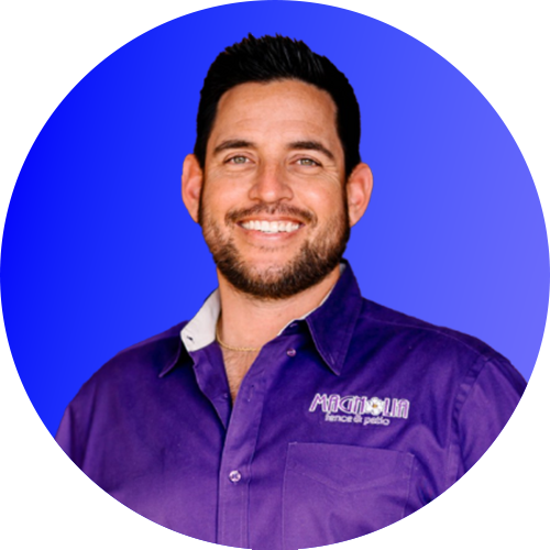 Smiling man in a purple shirt against a blue background
