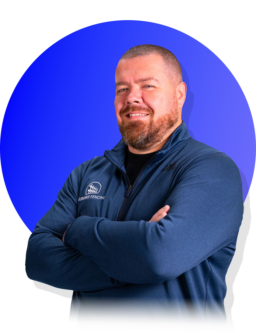 Smiling man with crossed arms in a blue jacket against a blue circular background
