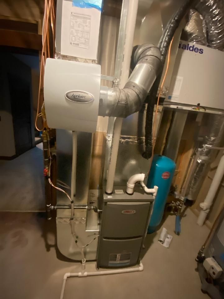 A picture of a heating system in a basement.