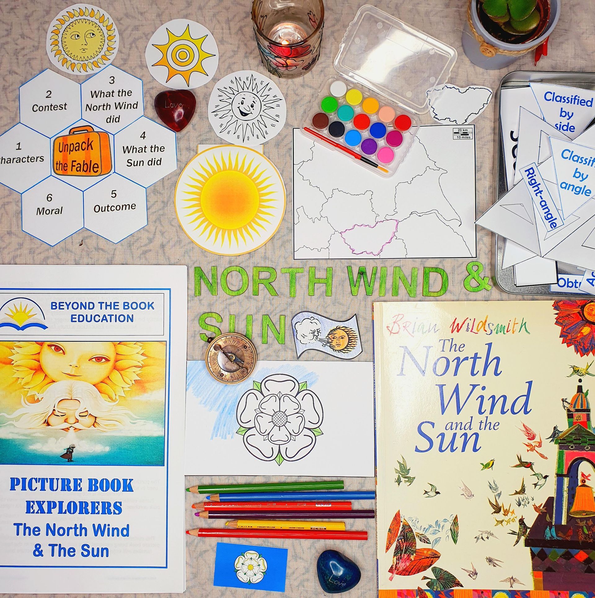 The North Wind & the Sun picture book surrounded by pencils, paints and worksheets