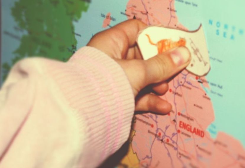 hand putting picture on a map