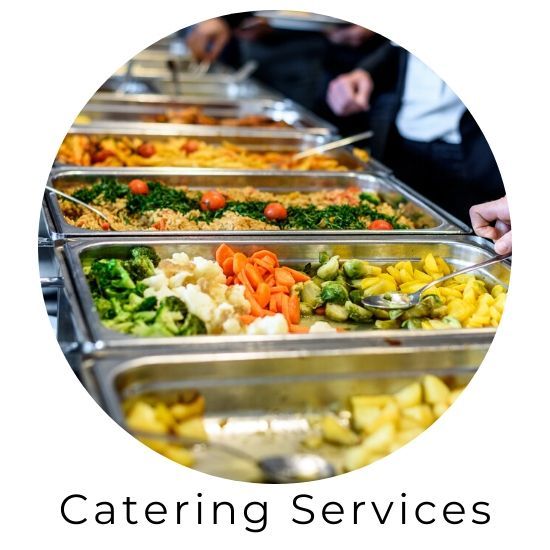 Catering buffet with trays of colorful prepared food and “Catering Services” text