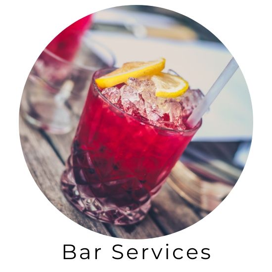 Red cocktail with lemon garnish in a glass, labeled Bar Services