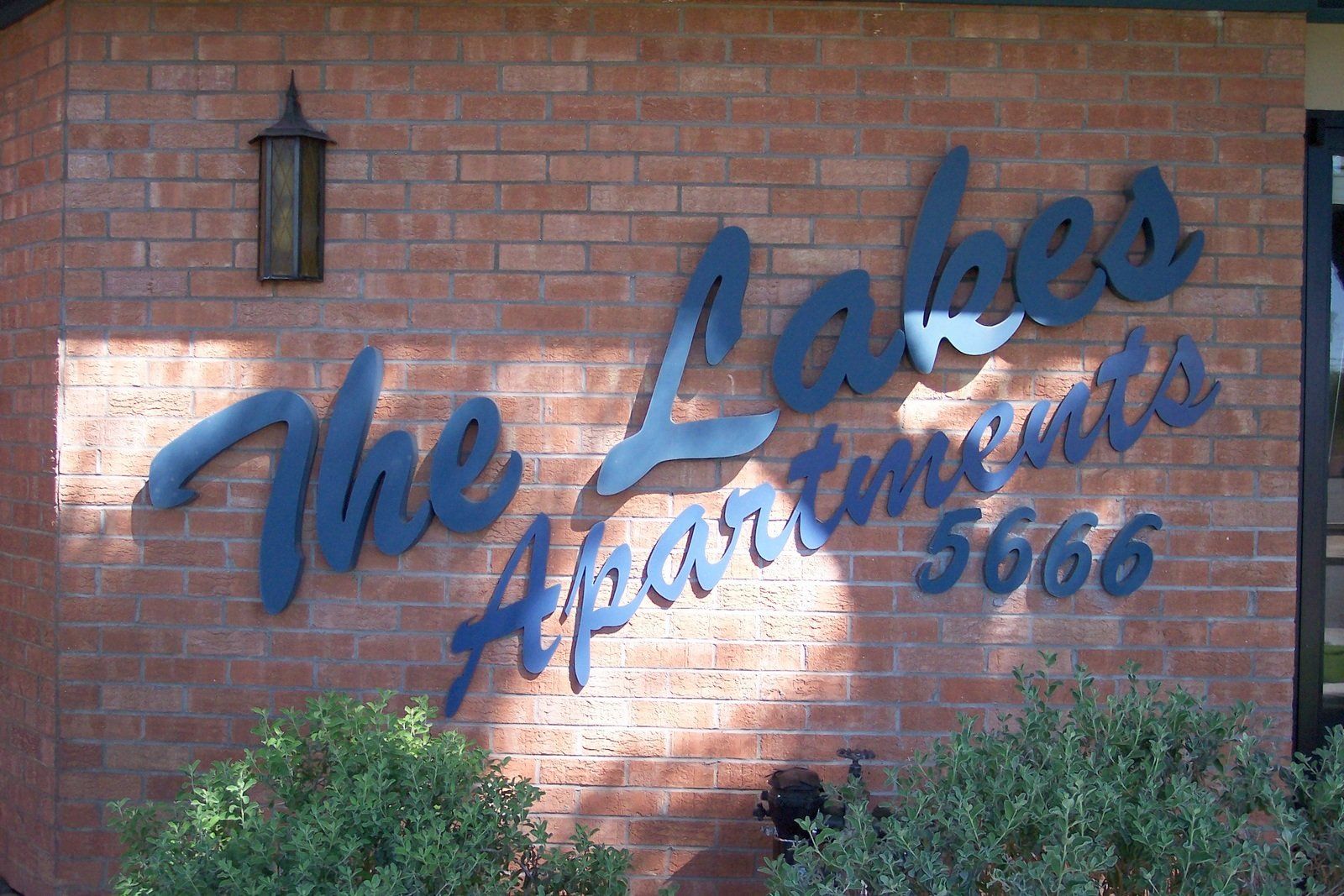 Exterior Photo of The Lakes Apartments Sign