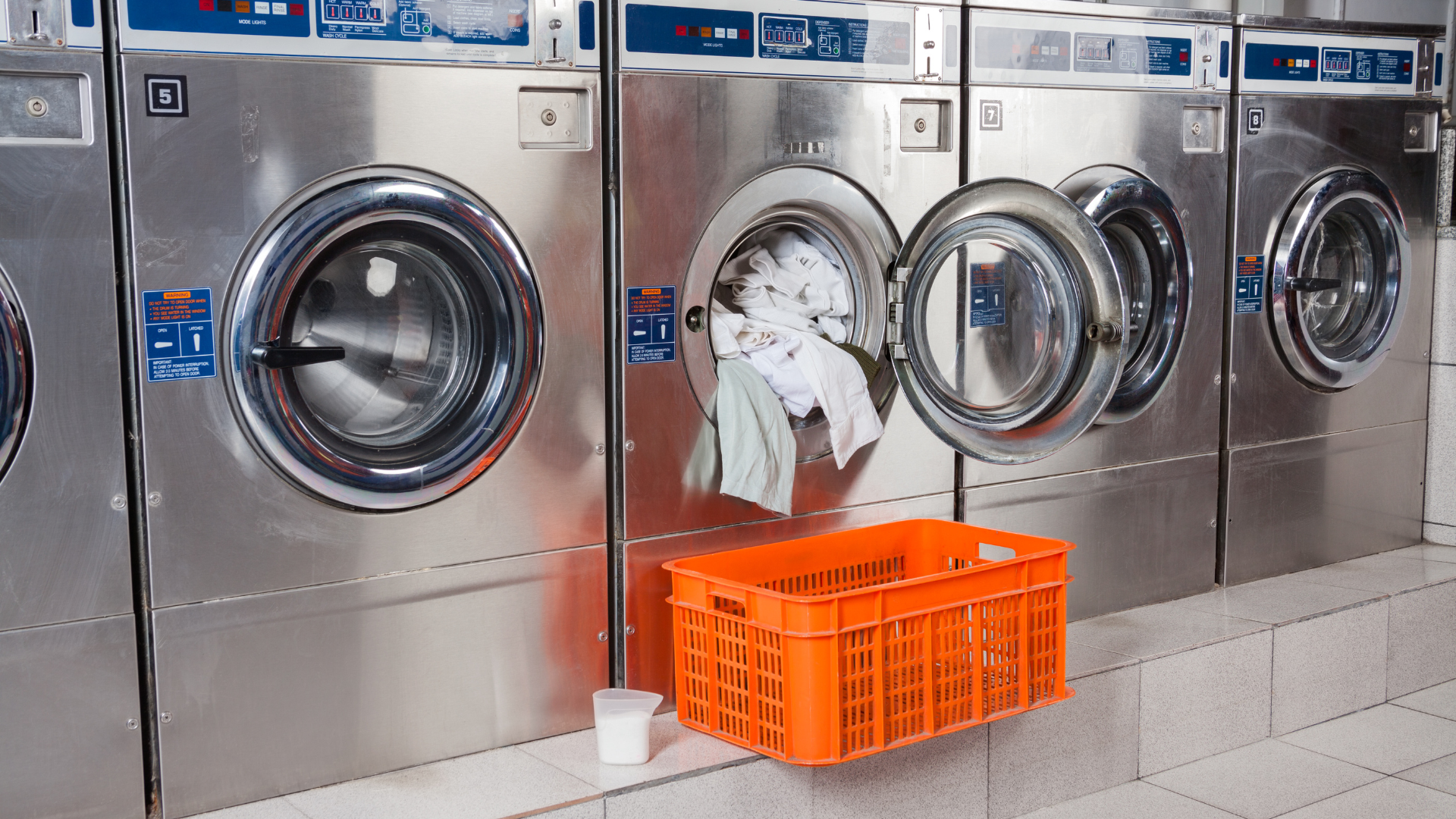 overloaded washer with shop towels and cleaning rags