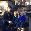 family sitting outside smiling