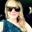 blonde woman with sunglasses smiling in car