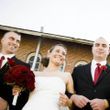 Family celebrating their wedding day in front of a brick building