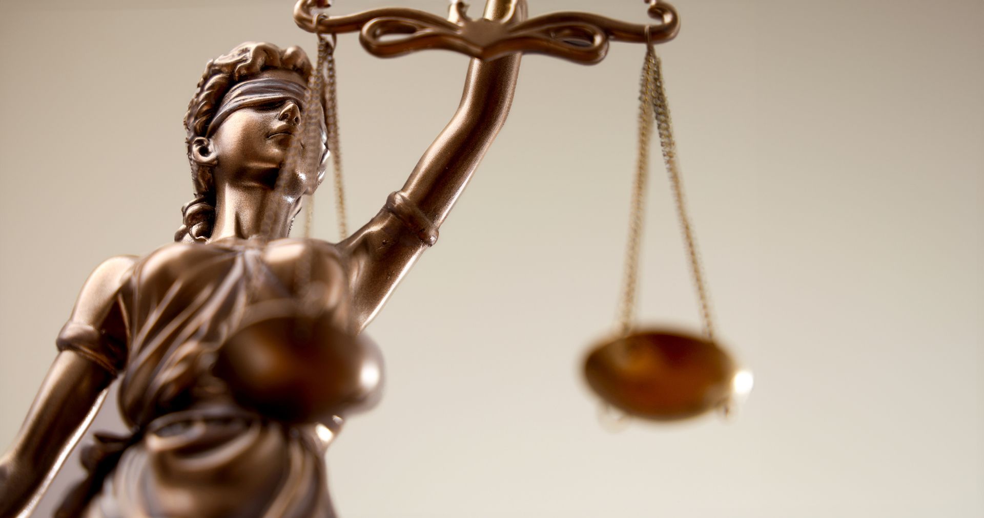 A man is sitting at a table with a judge 's gavel in front of him.