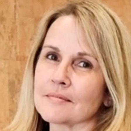 A close up of a woman 's face with a serious look on her face.