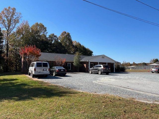 A white van is parked in front of a house