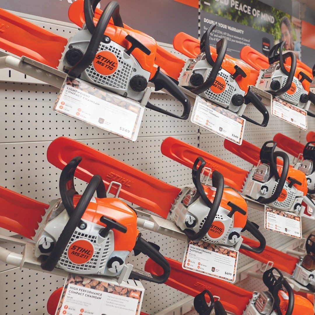 Chainsaws On Display In A Store, With Bright Orange Bars And Price Tags Visible — Stihl Shop Atherton In Atherton, QLD