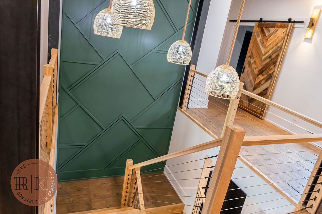 Home remodel custom wall molding with wicker dome lights and natural wood banister in Johnstown Ohio