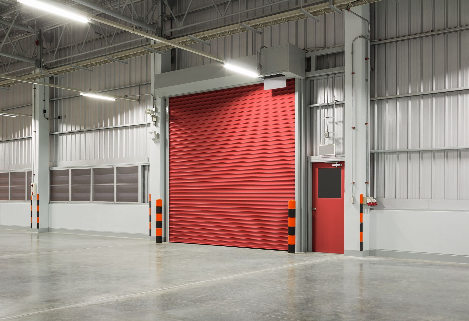 A red roller shutter from a commercial door supplier at a warehouse. A red roller shutter from a commercial door supplier at a warehouse.