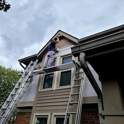 Man Working On The Exterior Of A House — Columbus, OH — Scotty’s Home Solutions