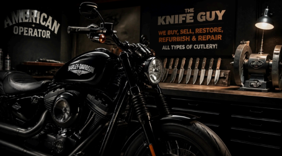 Black motorcycle in a dim workshop with “Knife Guy” sign and repair tools on the wall