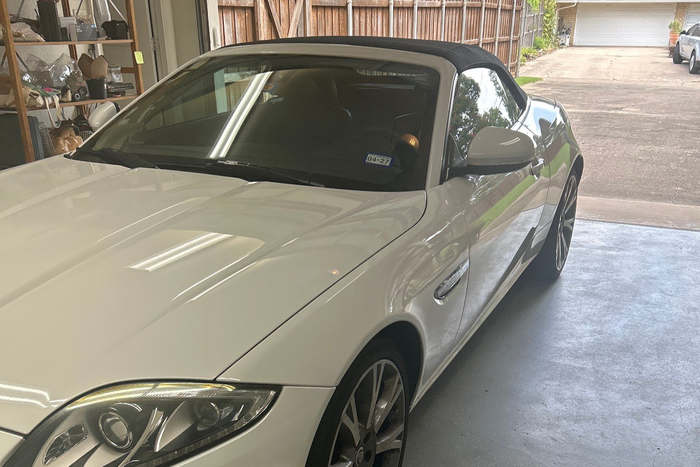 White convertible sports car parked in a garage, front-left view | DFW Auto Repair