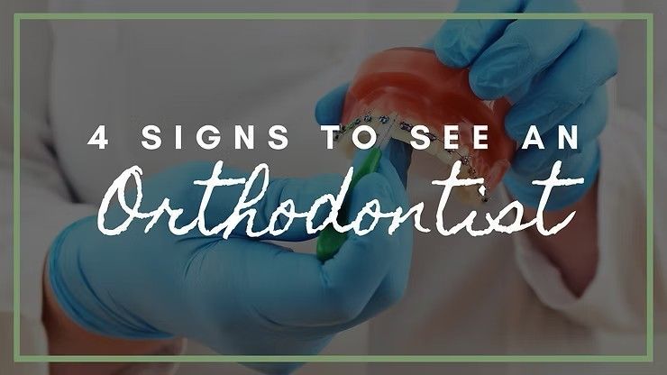 Dentist in mask and blue gloves examining teeth, with text: “4 signs to see an orthodontist”