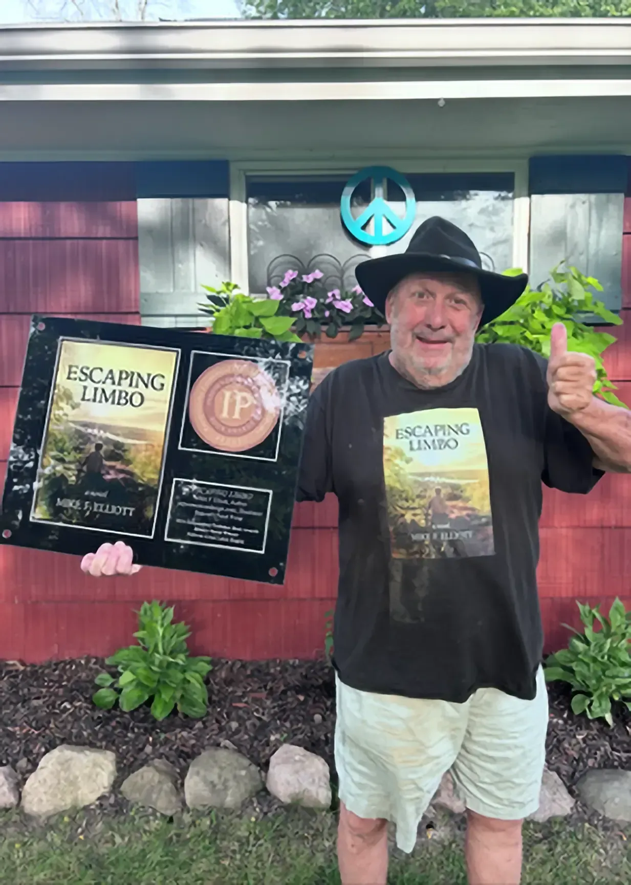 Man holding framed book cover 