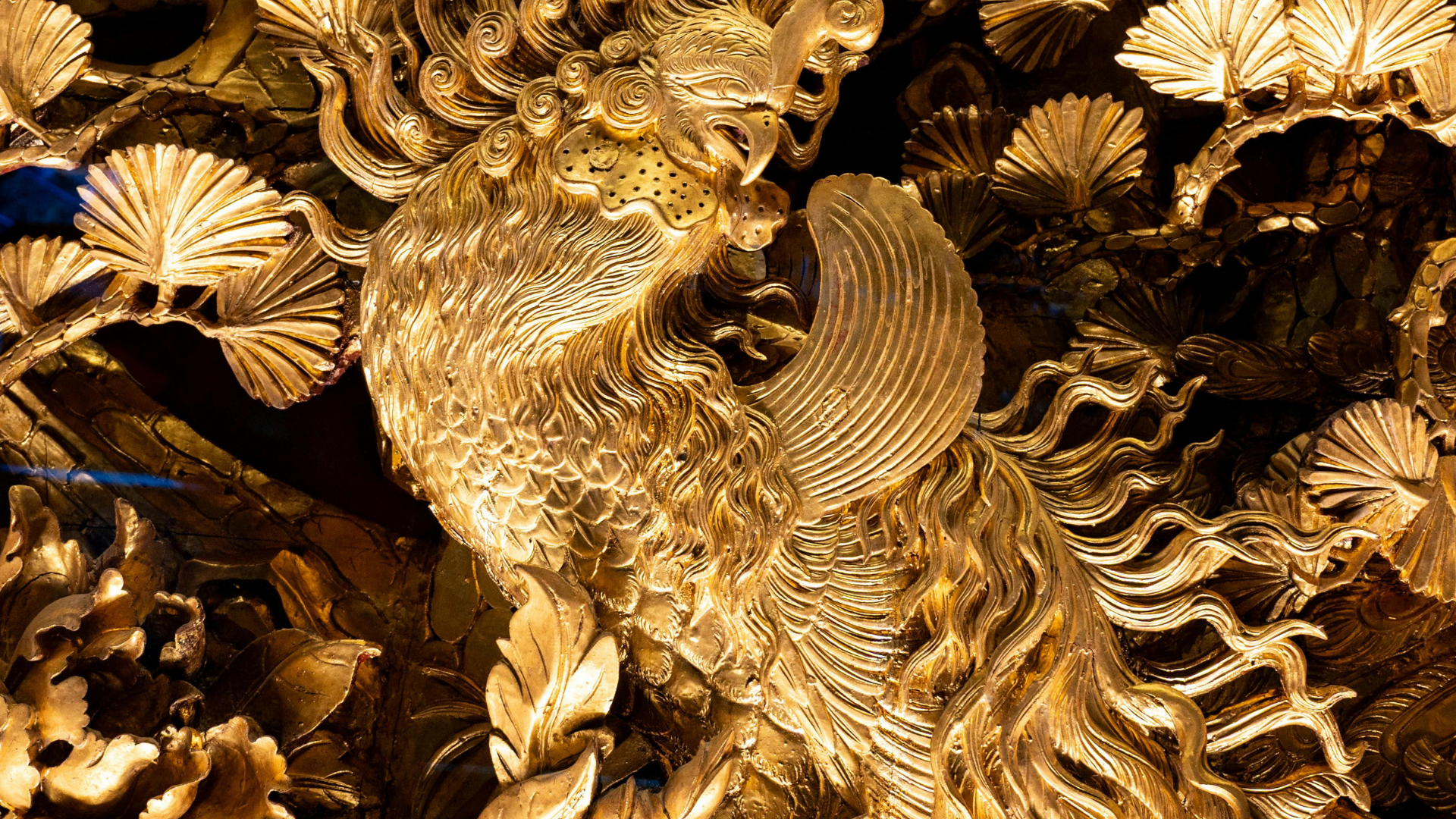 Golden carved dragon relief with ornate scales and swirling decorative patterns