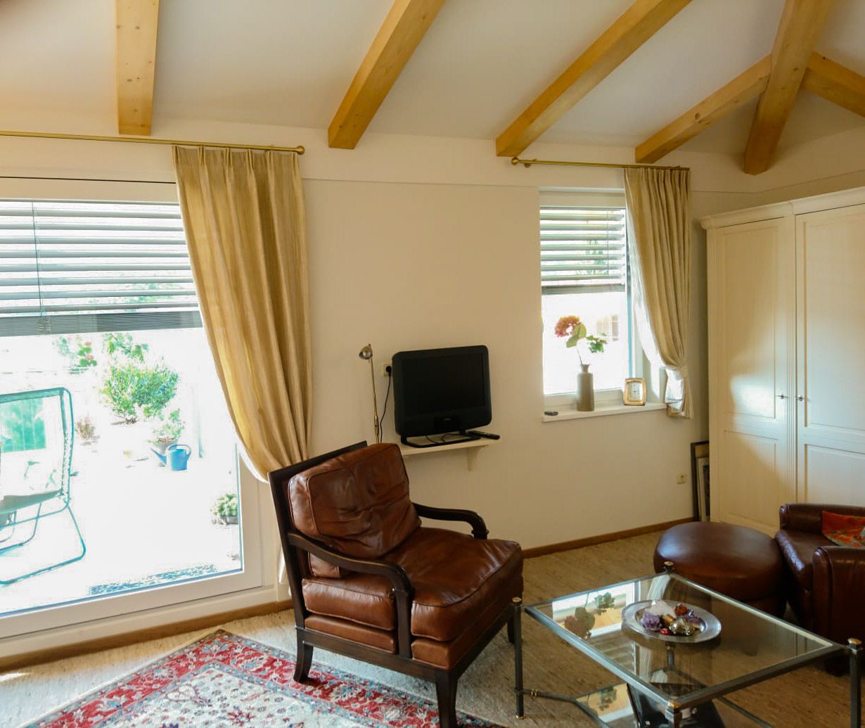 Ein Wohnzimmer mit einem Stuhl, einem Tisch und einem Fernseher