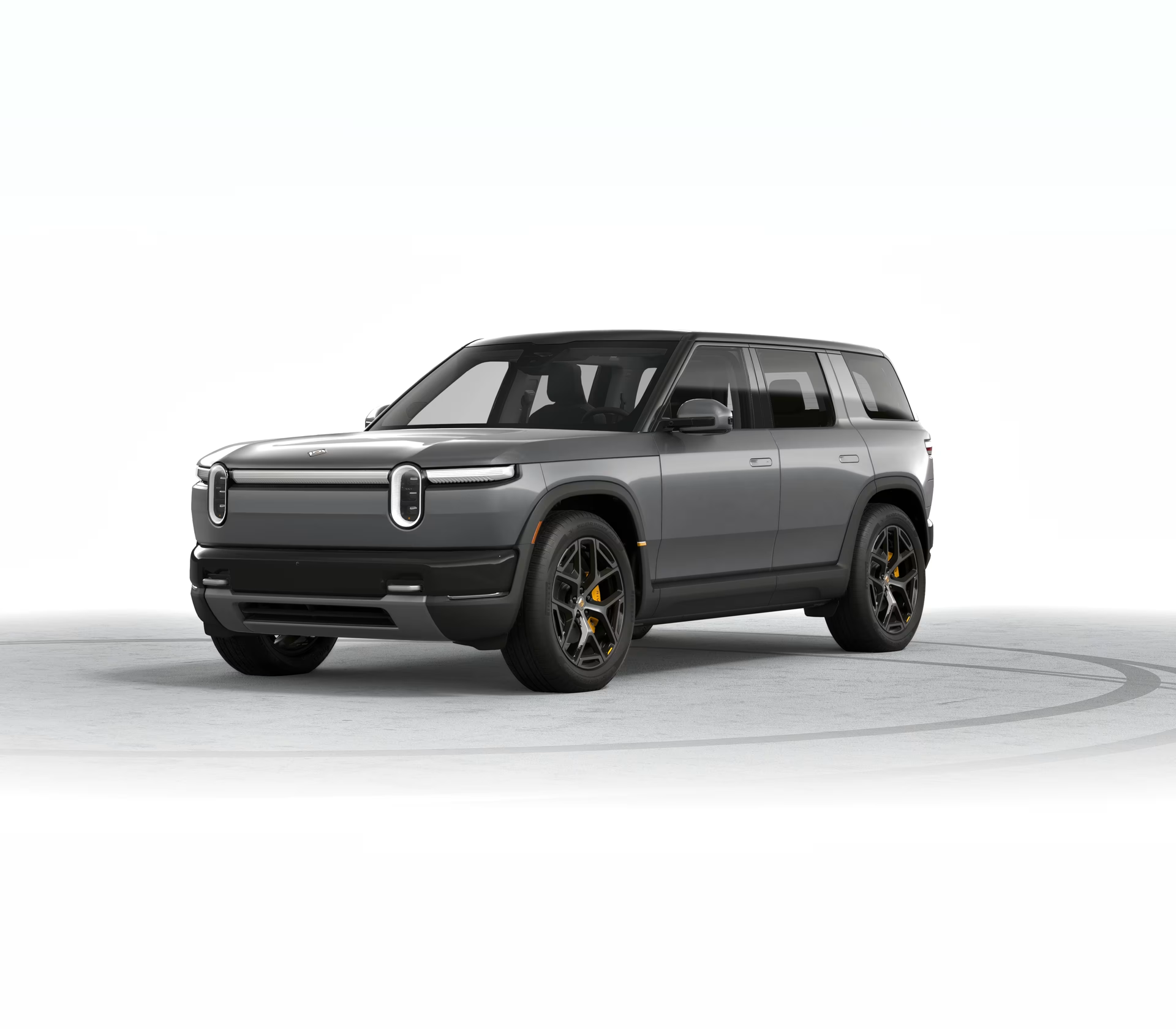 Gray electric SUV on a white studio background, shown in three-quarter front view