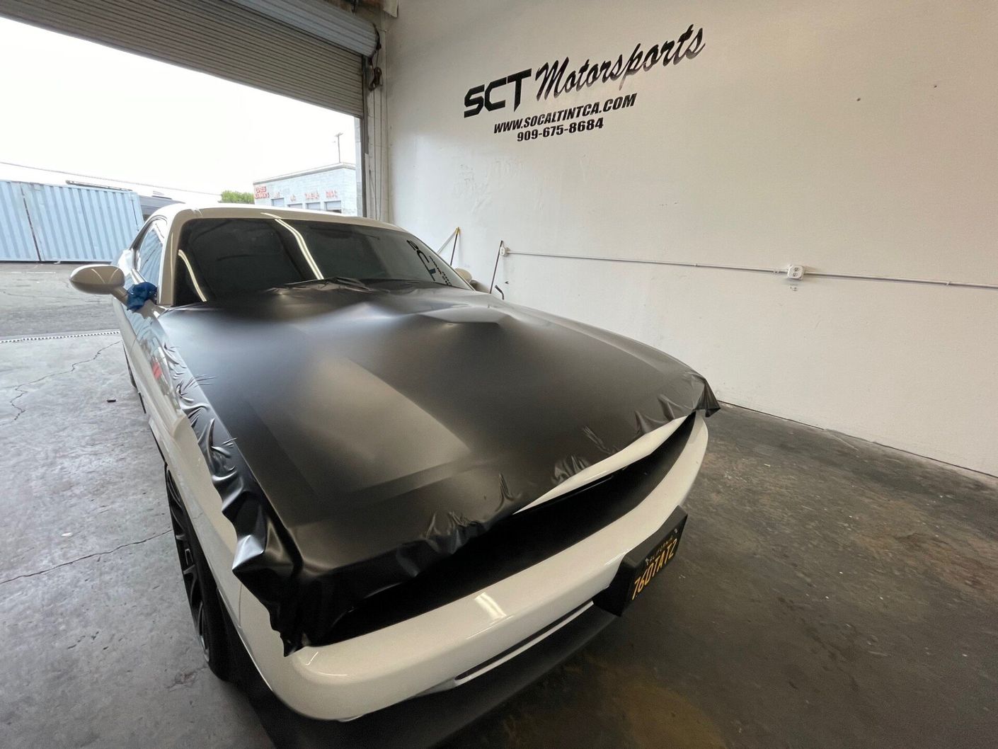 Applying Black Vinyl Wrapper On A White Car — Upland, CA — SoCal Tint