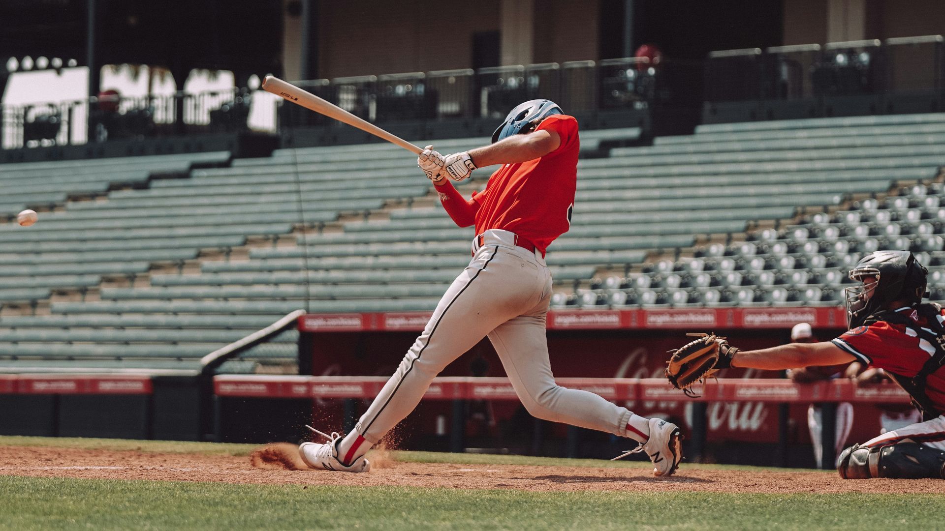 Baseball player swinging a bat at home plate