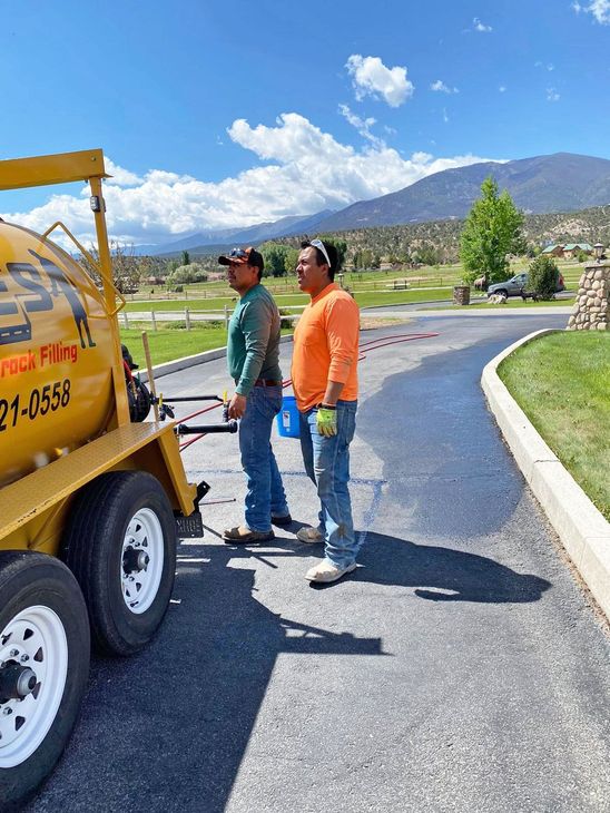 sealcoating with mountains in background