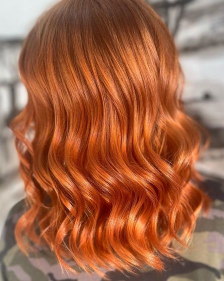 A Woman With Red Hair Is Getting Her Hair Done In A Salon — Genesis Hair and Beauty In Port Kembla, NSW