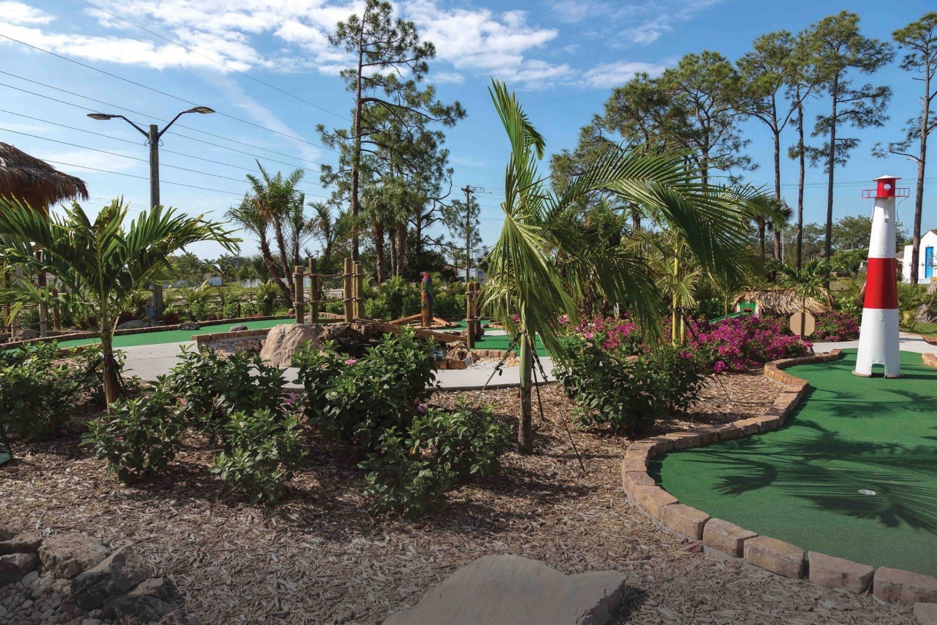 A mini golf course with a lighthouse in the middle of it