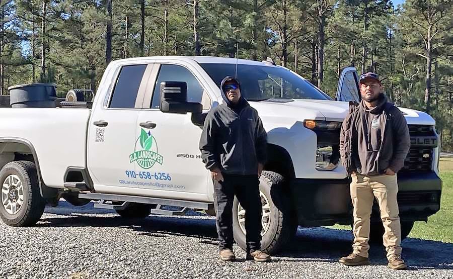 Owners posing by their truck
