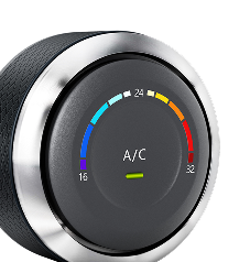 Car's A/C control dial. Black dial with temperature gauge from 16-32 degrees, indicated by color, with