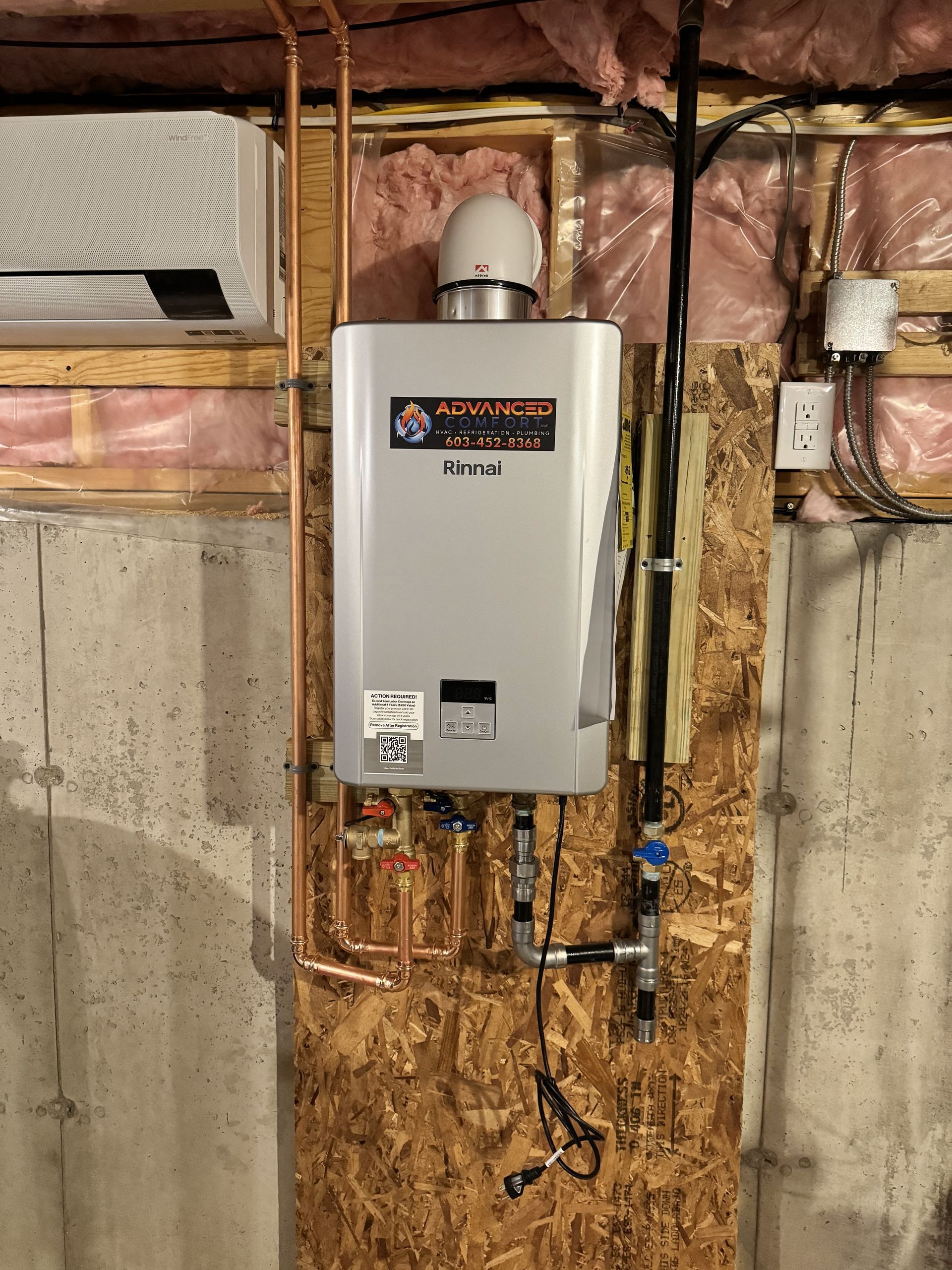 A water heater is hanging on a wall in a basement.