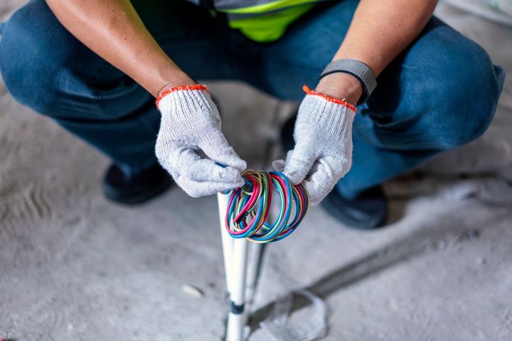 Electrician Holding Colorful Wires

