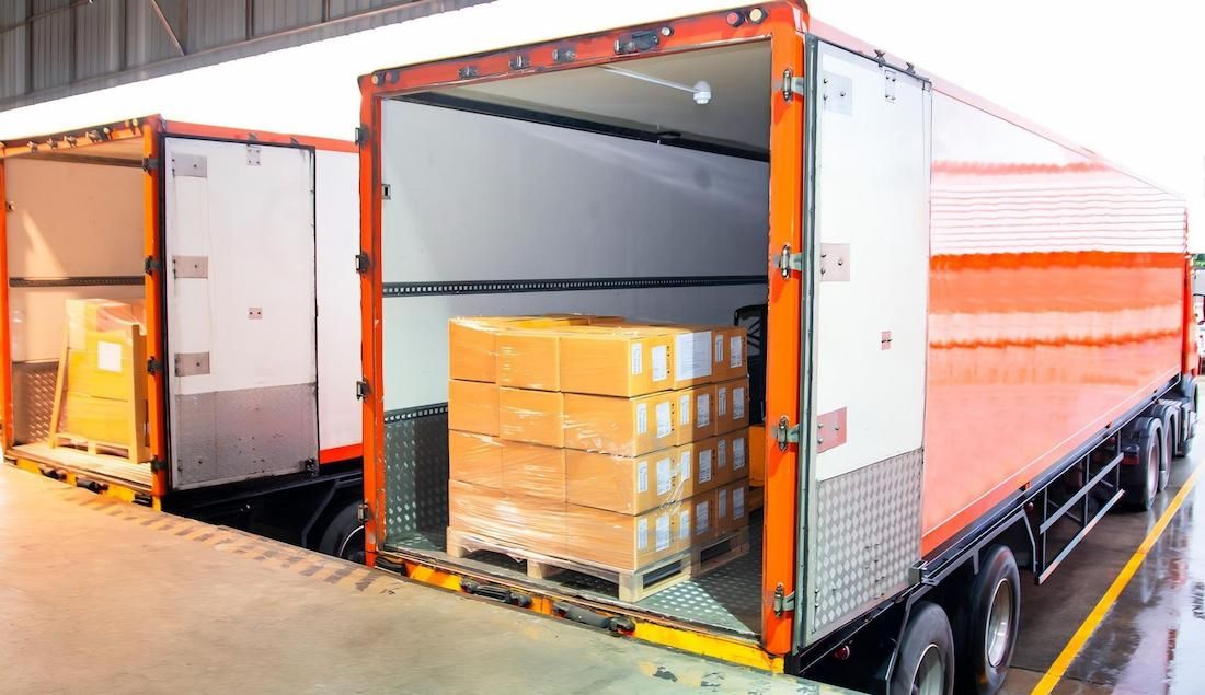 A Truck is Being Loaded With Boxes in a Warehouse — Dunford Removals in Miriam Vale, QLD