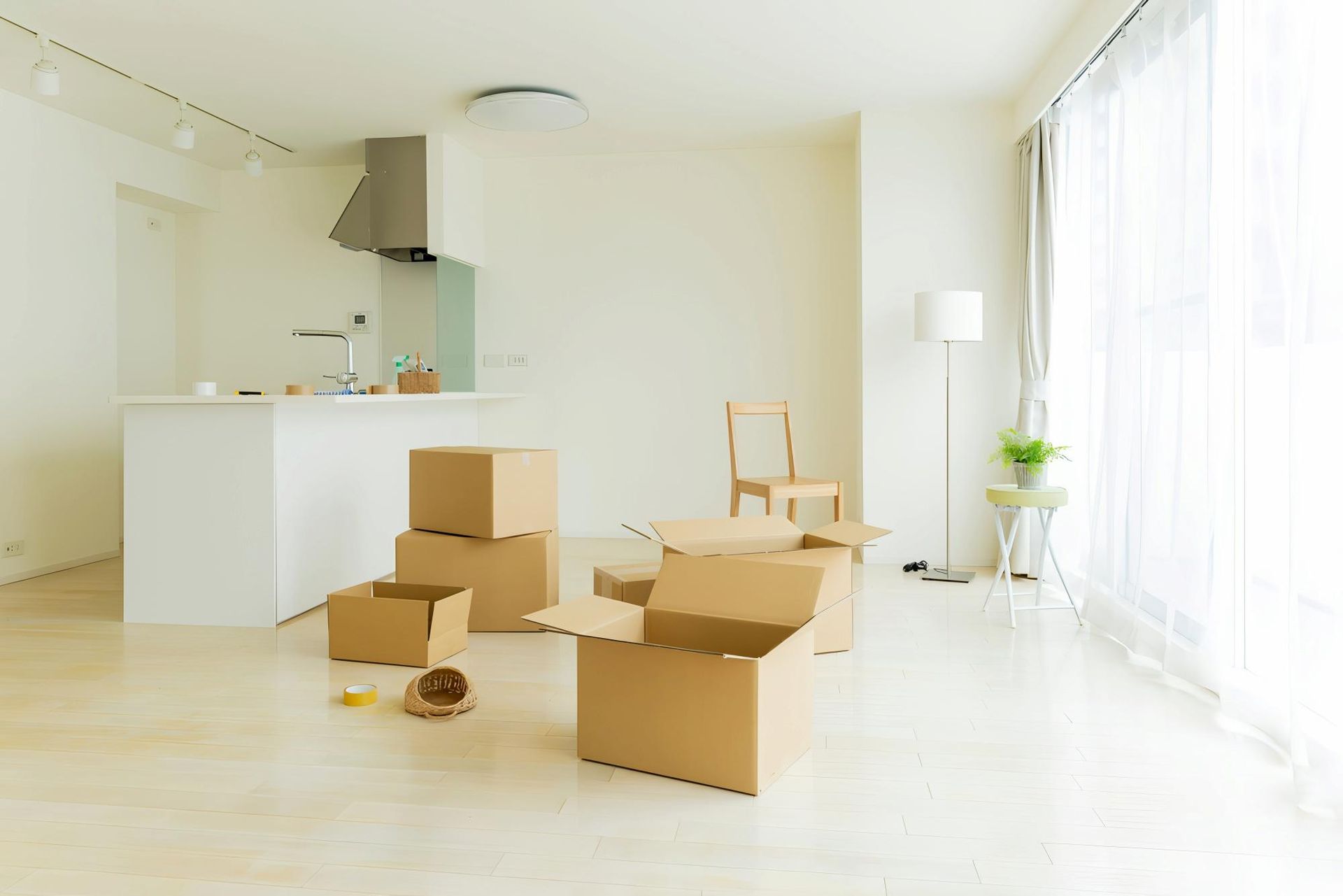 A Living Room With a Lot of Cardboard Boxes on the Floor — Dunford Removals in Biggenden, QLD