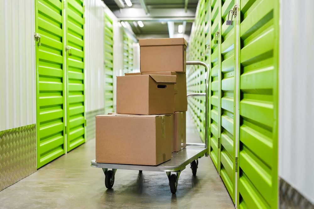 A Cart Filled With Cardboard Boxes in a Storage Room — Dunford Removals in Qunaba, QLD