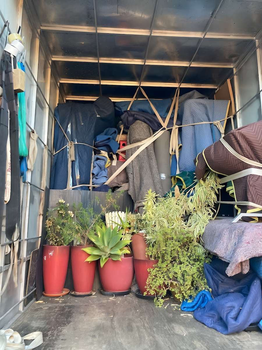 The Inside of a Moving Truck Filled With Potted Plants and Blankets — Dunford Removals in Gayndah, QLD