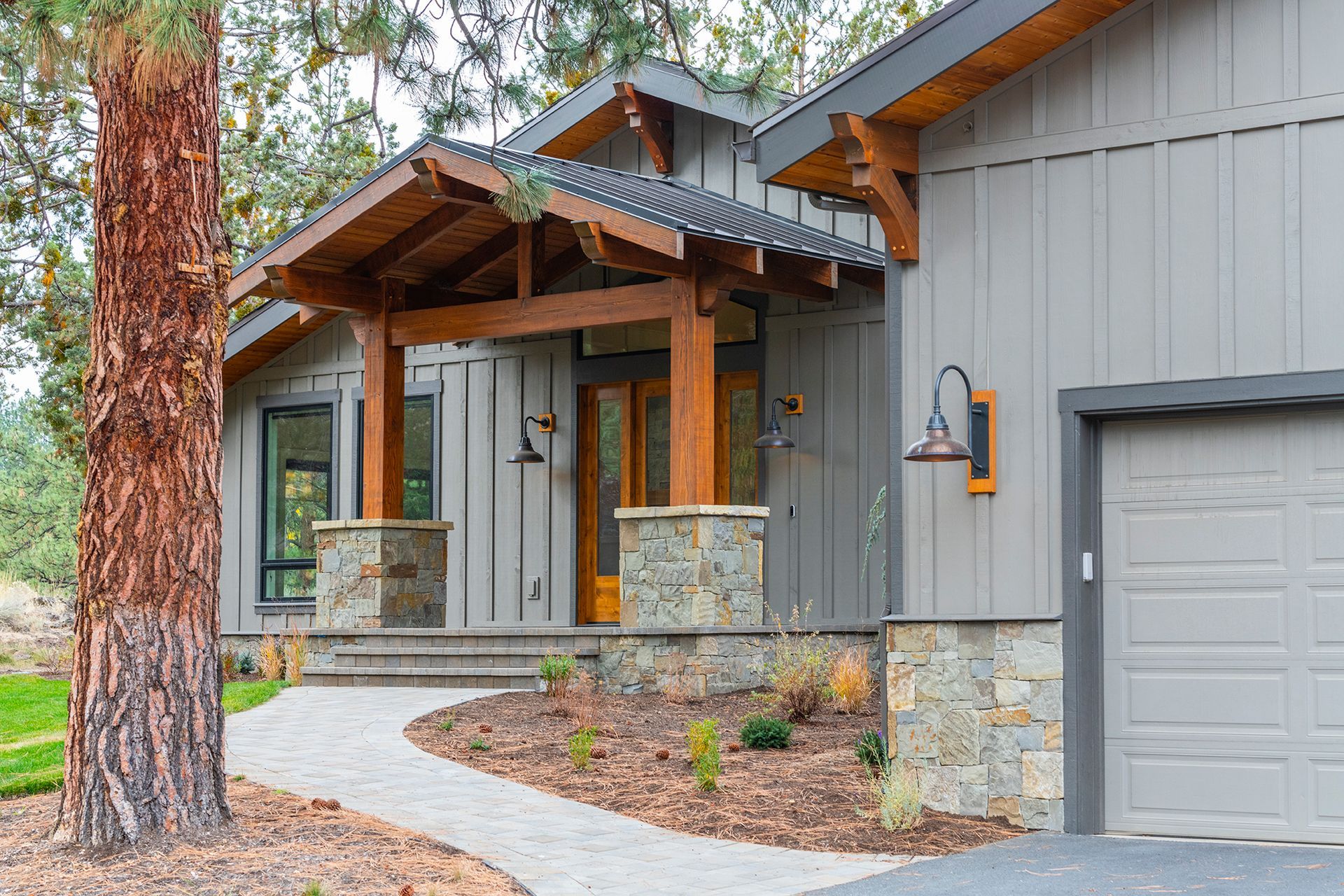 The front of a house with a walkway leading to it and a garage.