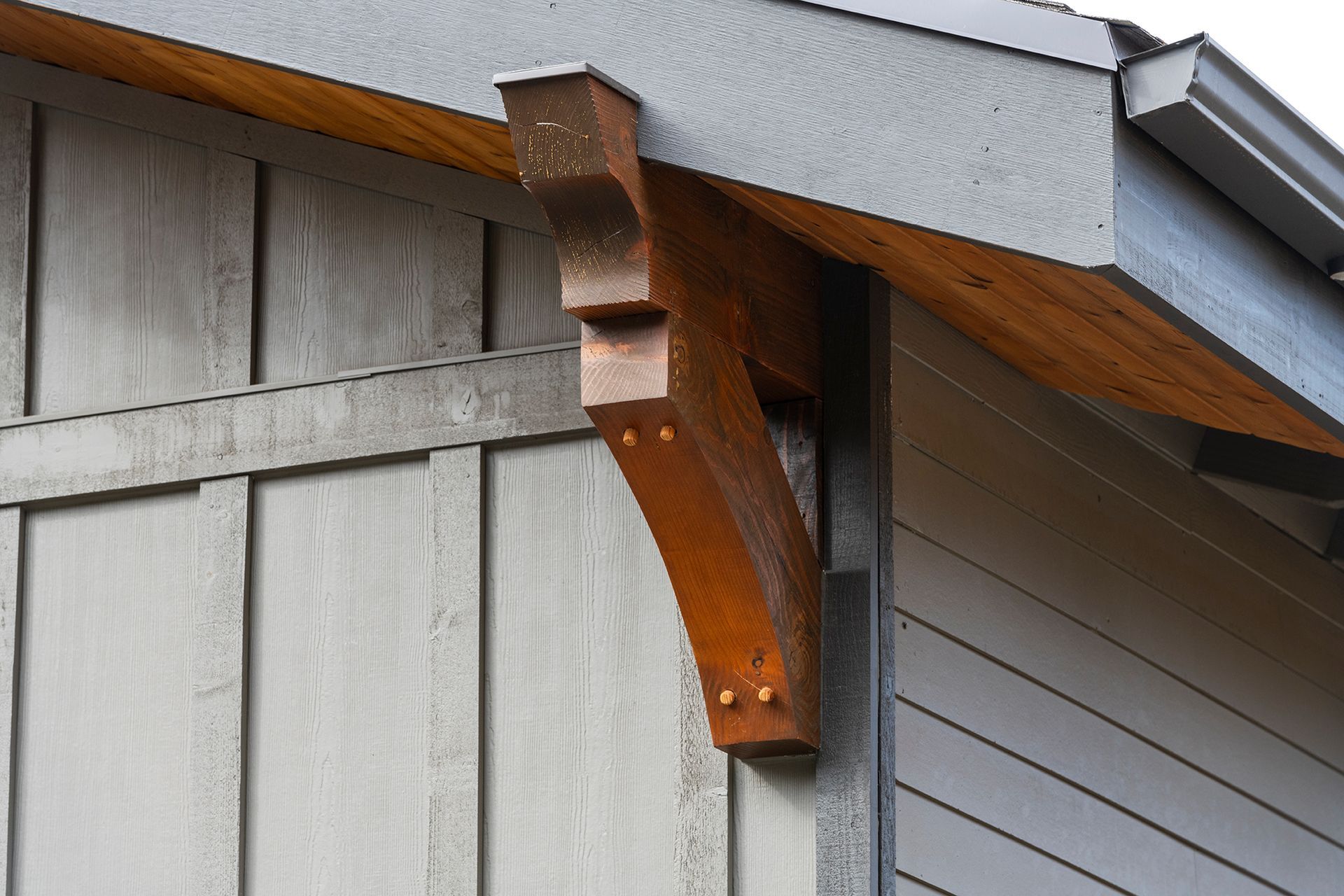 A wooden bracket is attached to the side of a building