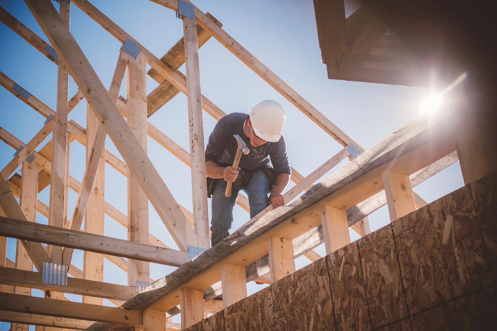 Custom Home Builder Working On Rooftop of Home in Bend, OR
