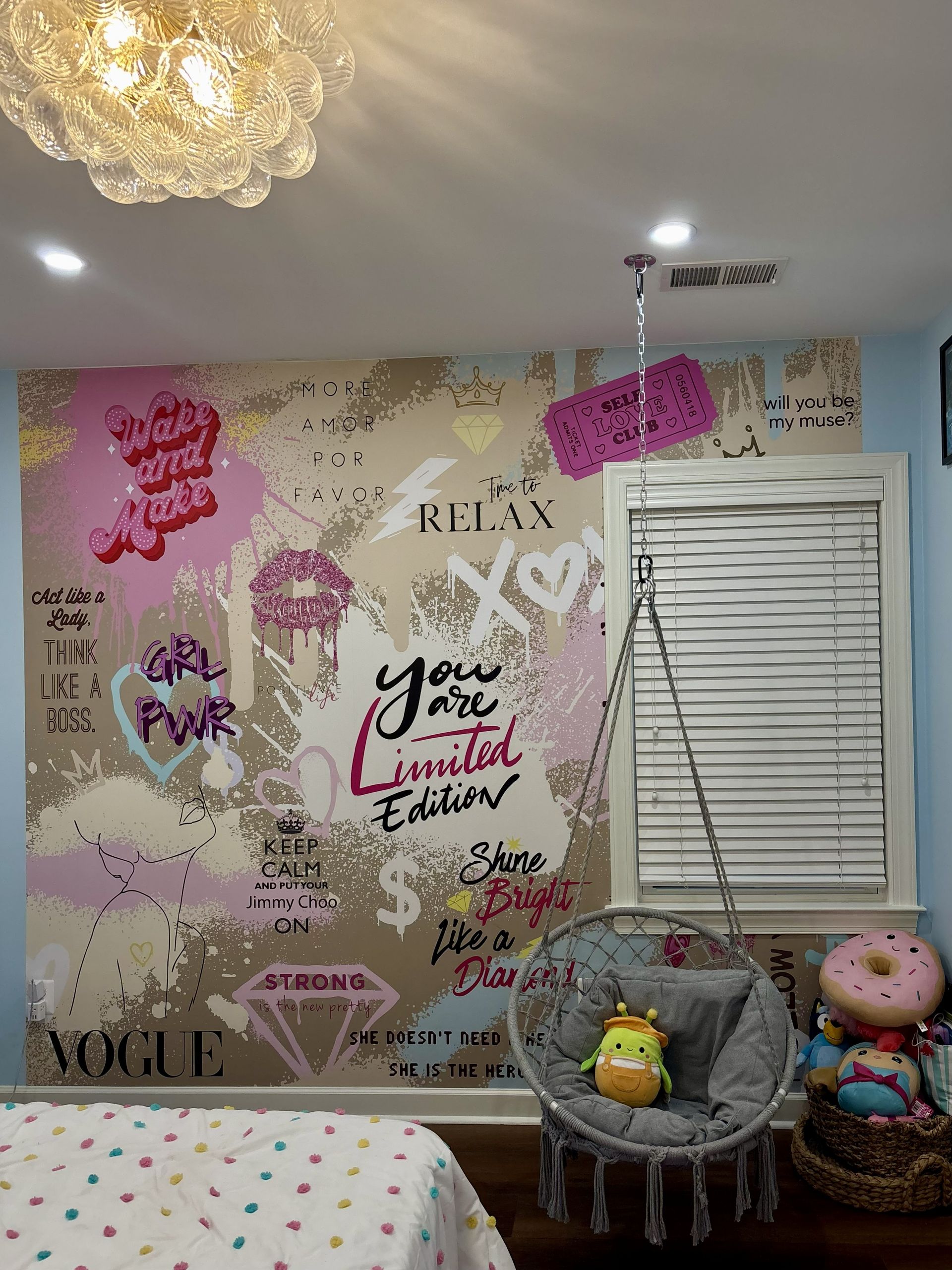 Decorated bedroom wall with inspirational quotes, butterfly decals, and two plush chairs with stuffed animals