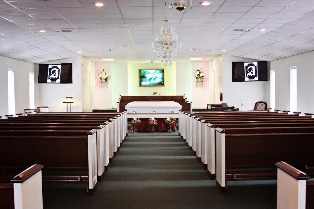 An empty church with a coffin in the middle