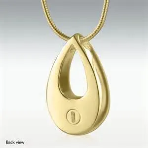 A gold necklace with a teardrop shaped pendant on a chain.